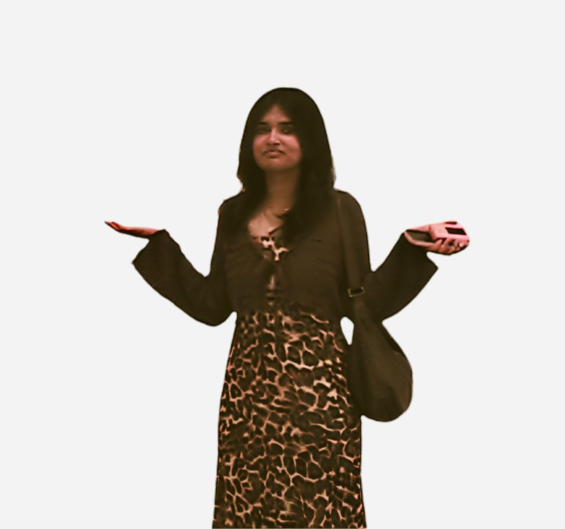 Shruthika Omkumar in a leopard-print dress, shrugging in a gallery